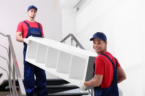 Staff using PPE while handling furniture in a property